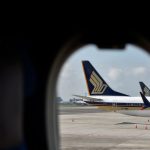 Singapore Airlines’ half-year profit nearly halves on rising costs