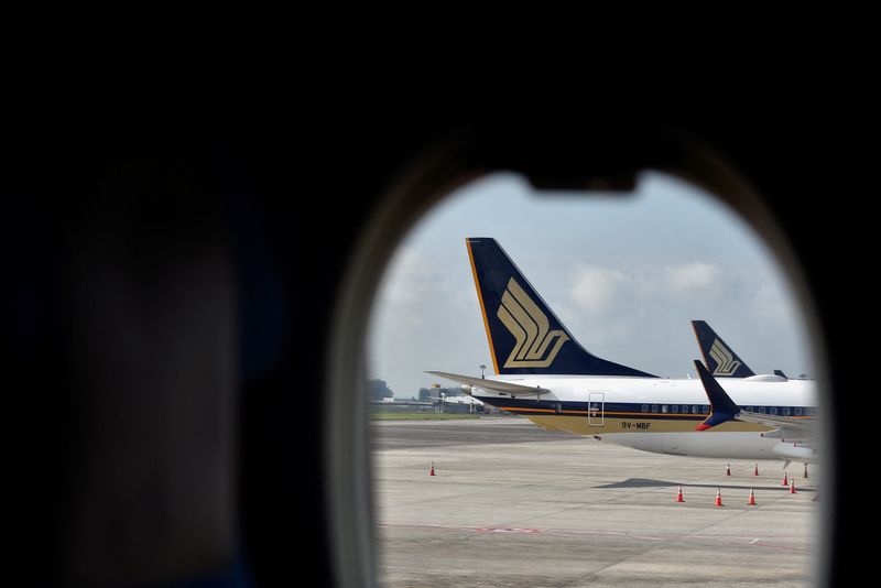 Singapore Airlines’ half-year profit nearly halves on rising costs